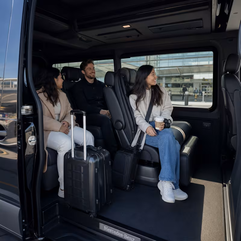 Passengers loading luggage while boarding an Bellevue group shuttle