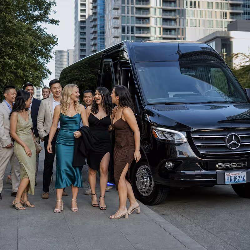 Group boarding a white charter bus for Bachelor & Bachelorette Transportation transportation in Bellevue