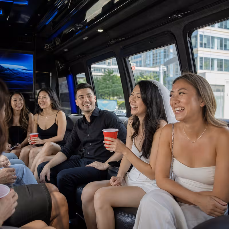 Party bus interior with wraparound leather seating and LED lighting in Bellevue