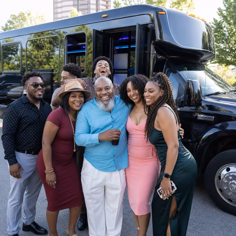 Group boarding a white charter bus for Birthday Transportation transportation in Bellevue