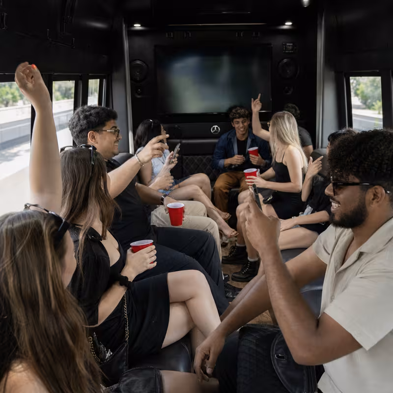Group boarding a white charter bus for Concert Transportation transportation in Bellevue
