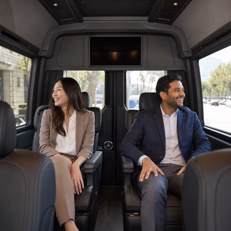 Group boarding a white charter bus for Corporate Transportation transportation in Bellevue