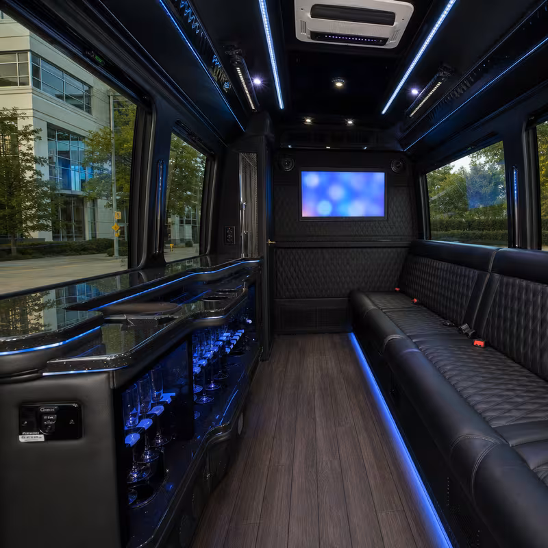 Party bus interior with wraparound leather seating and LED lighting in Bellevue