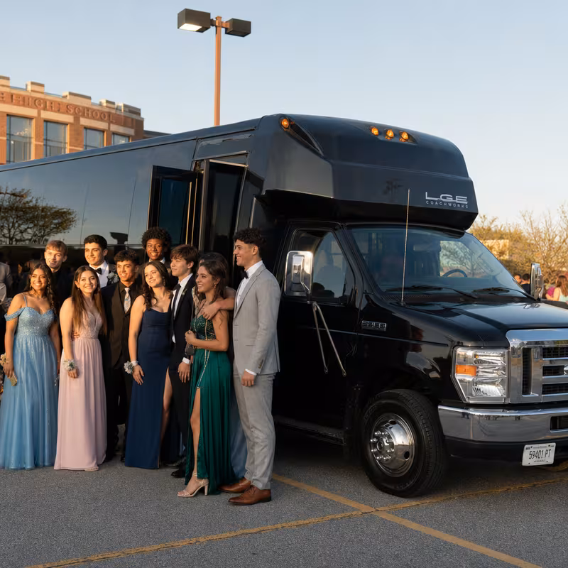 Group boarding a white charter bus for Prom & Homecoming Transportation transportation in Bellevue