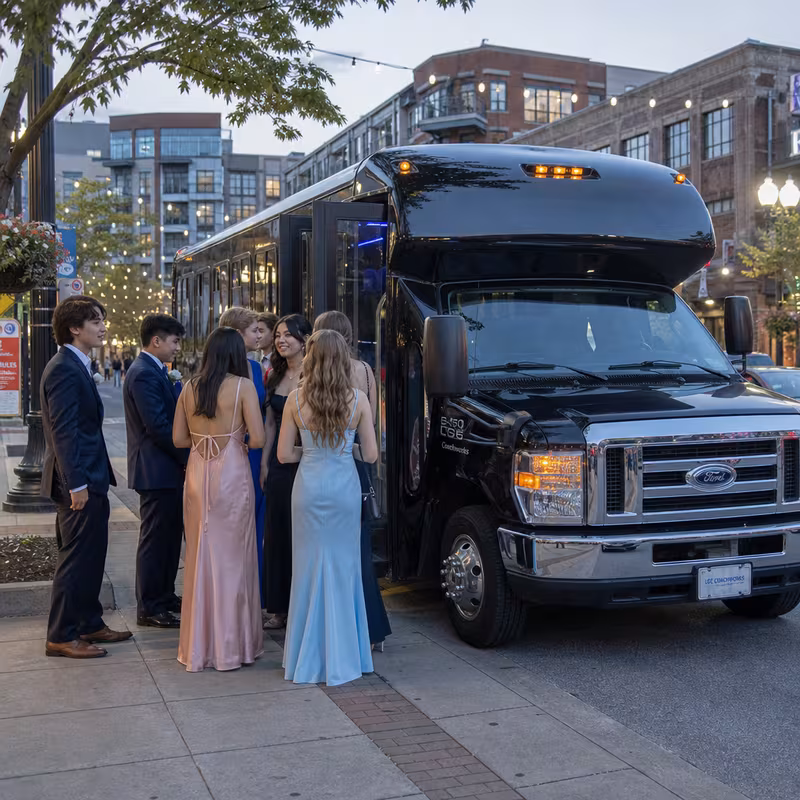 Passengers loading luggage while boarding an Bellevue group shuttle