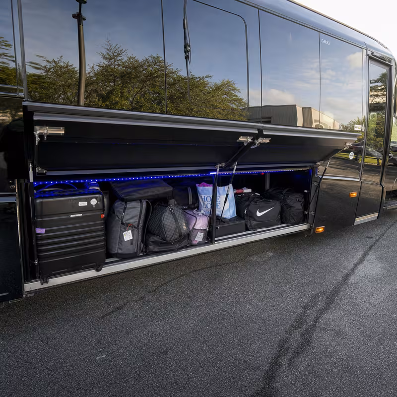 Party bus interior with wraparound leather seating and LED lighting in Bellevue