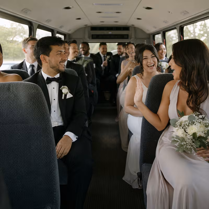Group boarding a white charter bus for Wedding Transportation transportation in Bellevue