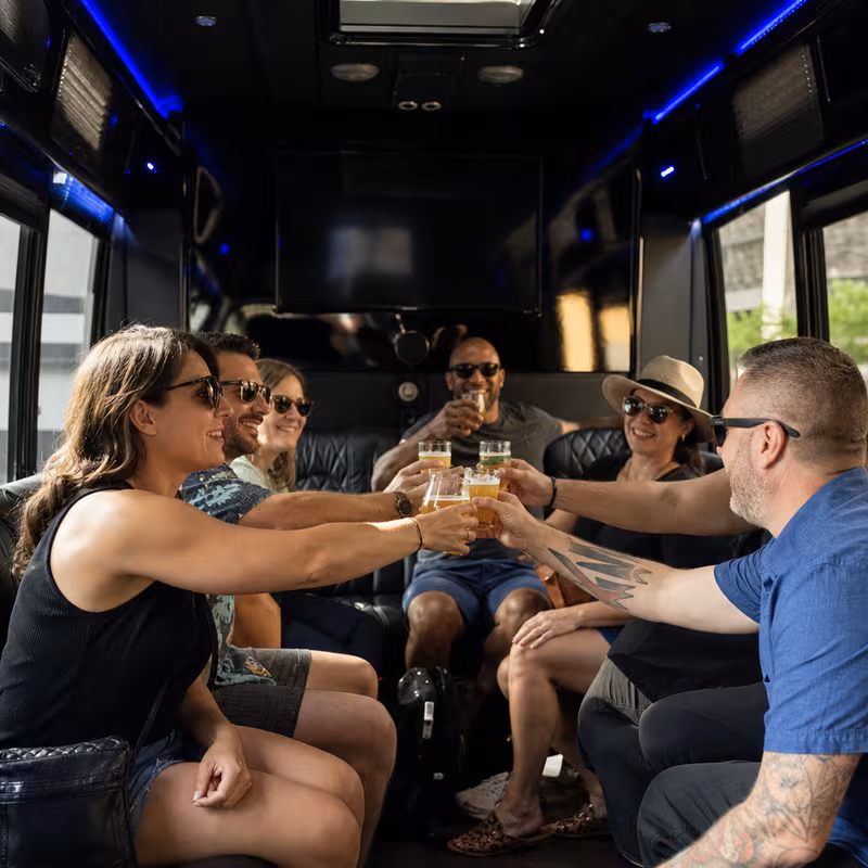 Group boarding a white charter bus for Winery & Brewery Tour Transportation transportation in Bellevue