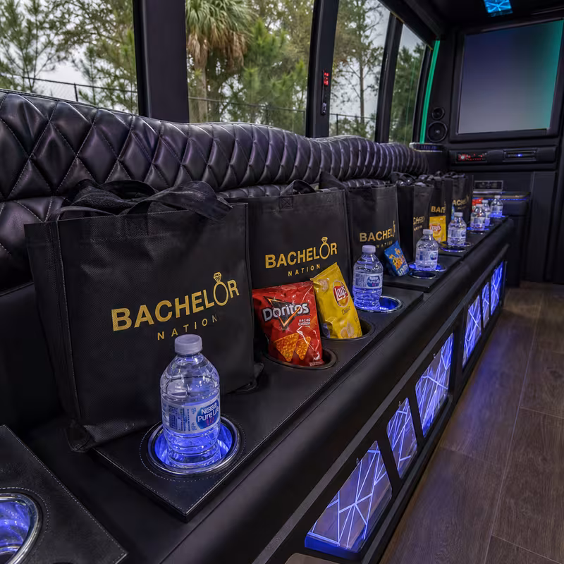 Party bus interior with wraparound leather seating and LED lighting in Bellevue